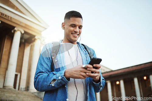 Image of Happy man, earphones or phone on university, school or college campus on social media, education podcast or learning music. Smile, mobile technology or student listening to motivation radio on 5g app