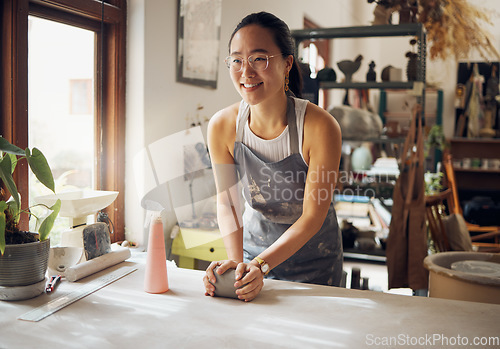 Image of Asian, woman and artist in clay studio, workshop and creative startup to sculpture product. Ceramic designer, creative pottery process and production, manufacturing and creativity in small business