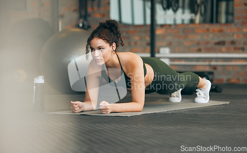 Image of Fitness, gym and workout of a woman doing plank exercise or training for wellness with focus for healthy lifestyle. Female athlete with body weight routine for strong core, sports health and balance