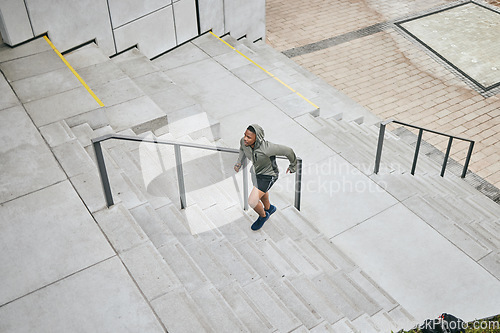 Image of Running, stairs and city with a sports black man from above for a cardio or endurance workout for fitness. Training, exercise or motivation with a male runner or athlete moving up an urban staircase