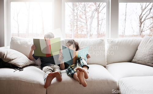 Image of Kids, bonding reading books in education, learning or relax studying on house living room or family home sofa. Happy children, storytelling or fantasy fairytale novel in hobby or creative inspiration