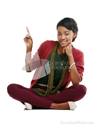 Image of African woman, happy portrait and pointing finger, relax sitting isolated in white background for advertising mockup. Black woman, smile and point for marketing, product placement or idea vision