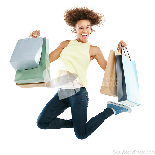 Image of Shopping bag, jump and black woman in studio portrait for retail sale, winning or celebration advertising or marketing. Shopping, celebrate and winner or excited customer isolated on white background