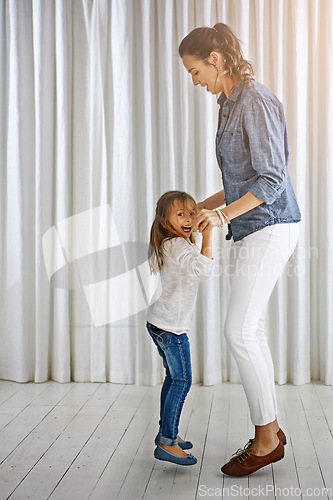 Image of Dance, family and mother with girl in a living room for fun, bonding and teaching dancing steps in their home. Love, mom and daughter playing, laughing and relax in their lounge, weekend and positive