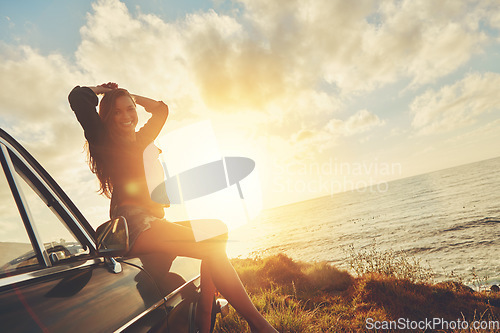 Image of Woman, sunset portrait and road trip on hood of car with smile, beach or happiness for summer vacation. Happy gen z girl, sky and sunshine with nature, outdoor adventure and holiday by ocean in Miami