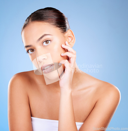 Image of Portrait, skincare and woman with natural beauty, cosmetics and on blue studio background. Face, female and girl with makeup, treatment for glow and luxury routine for smooth, clear and soft skin.