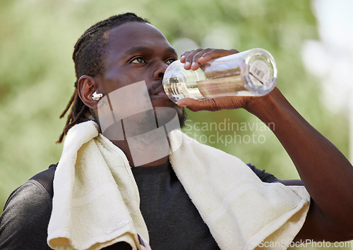 Image of Water, fitness break and black man running in nature, exercise hydration and focus on body performance in Germany. Thirsty, training and African runner thinking of cardio workout in park with a drink