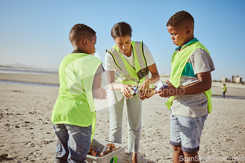 Image of Plastic, beach volunteering and woman with children recycling, cleaning and learning, education or community for pollution. Family, mother and kids recycle with teamwork, project goals and earth day