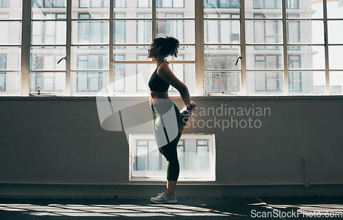 Image of Exercise, stretching and a woman at gym for fitness workout for health and body wellness with muscle warm up. Sports female or athlete stretch legs at window for balance, energy and healthy lifestyle