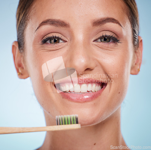 Image of Brushing teeth, dental and woman with toothbrush for teeth whitening and beauty, oral health and fresh breath with studio background. Mouth wellness, Invisalign portrait and clean with bamboo brush.