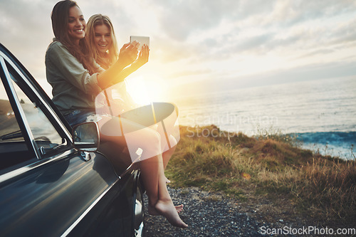 Image of Friends at sunset, women and selfie on beach, travel and adventure on car outdoor, nature and sea holiday. Road trip mockup, happy in picture on summer vacation, smartphone photography and lens flare