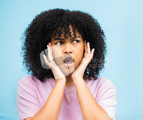 Image of Shock, surprise face and black woman with isolated blue background in a studio. Wow, thinking and hands of a young person hearing a secret or surprising announcement feeling confused and annoyed