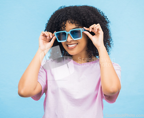 Image of Black woman, sunglasses and smile on a blue background with happy positive attitude and casual summer style. Portrait of African American female, person or lady model smiling in happiness for fashion