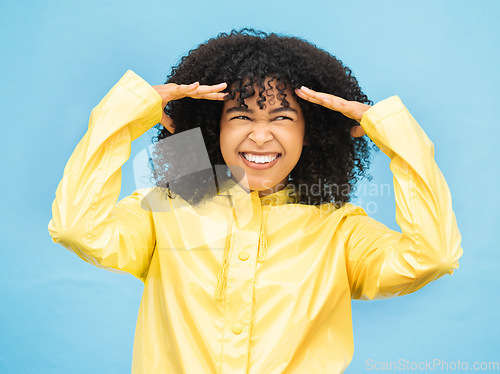 Image of Face, thinking and laugh with a black woman on a blue background in studio for fun or laughter. Idea, joy and humor with an attractive young afro female laughing on a color wall for enjoyment