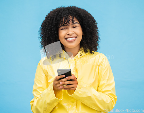 Image of Black woman, portrait and phone with a person smile with blue studio background, Isolated, happiness and social media mobile communication of a female ready to text and connect on a cellphone
