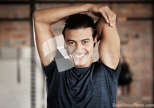 Image of Arm stretch, gym fitness and portrait of a man ready for exercise, training and wellness workout. Happy, smile and excited young person about to start sport health by stretching for sports alone