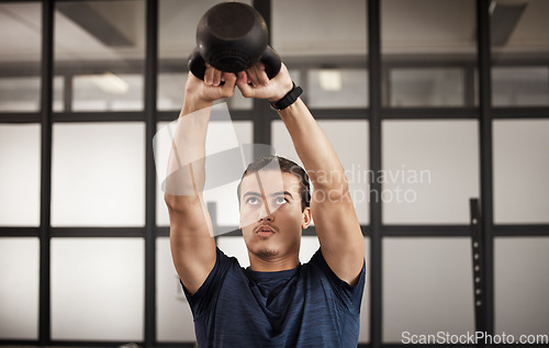 Image of Man, kettlebell and gym fitness of a person training with focus mindset in a health studio. Power train, weight workout and wellness target goal of an athlete doing cardio and arm challenge breathing