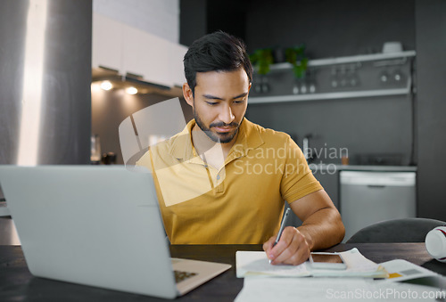 Image of Laptop, writing and notebook with a freelance man doing remote work from home on research in his small business startup. House, computer and notes with a male entrepreneur working in his house