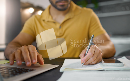 Image of Businessman, hands and writing with pen by laptop for accounting, finance or planning schedule at home. Hand of male, person or remote employee busy with paperwork, diary or book for financial plan