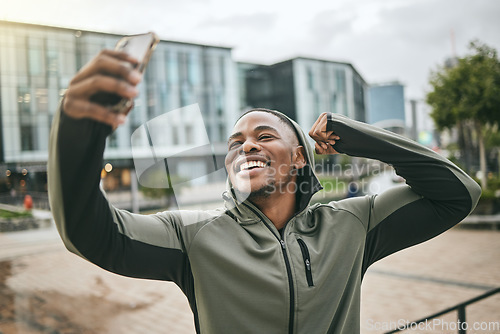 Image of Fitness, phone selfie and black man in city taking picture for social media or happy memory outdoors in winter. Sports, training or male with 5g smartphone taking a photo showing arm muscle on street