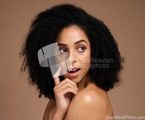 Image of Hair, beauty and black woman with hair care and surprise, wow and skincare with microblading, healthy skin and glow. Natural curly hair, hand and cosmetic care with facial against studio background