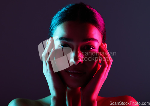 Image of Beauty, neon shadow light and portrait of woman with dark lighting, facial cosmetics and skincare glow. Luxury studio makeup, aesthetic creativity and face model with creative pink blue color design