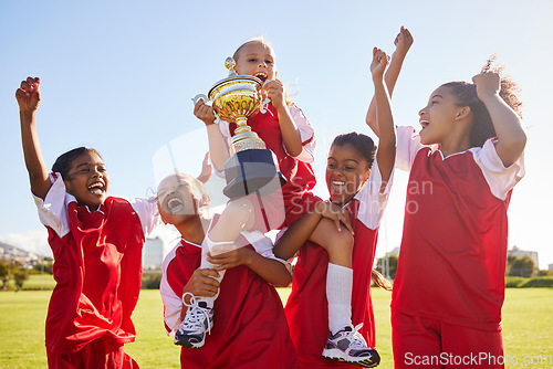 Image of Soccer, team and trophy with children in celebration together as a girl winner group for a sports competition. Football, teamwork and award with soccer player kids celebrating success in sport