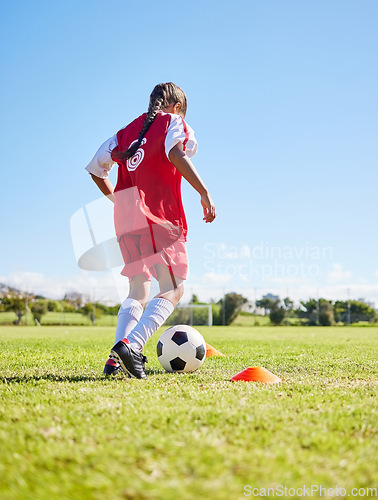 Image of Sports, training and girl playing soccer for fitness, physical activity and hobby on a field in Spain. Active, focus and athlete dribbling a football for a game, cardio and match on the grass