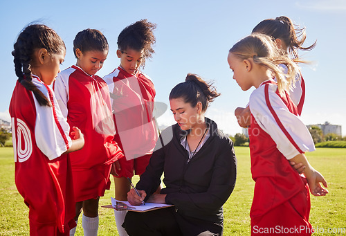 Image of Planning, sports and coach with children for soccer strategy, training and team goals in England. Plan, teamwork and woman coaching a group of girls on football for a game, match or competition