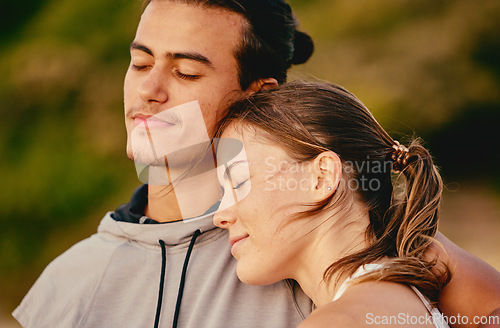 Image of Couple, smile and hug embracing relationship for real quality bonding time together in the outdoors. Man and woman enjoying calm relaxation in romance, hugging or care in love for fresh air in nature