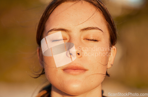 Image of Face, relax and peace with a woman outdoor in nature, standing alone for zen, calm or serenity. Mindset, wellness and mental health with an attractive young female breathing outside for mindfulness