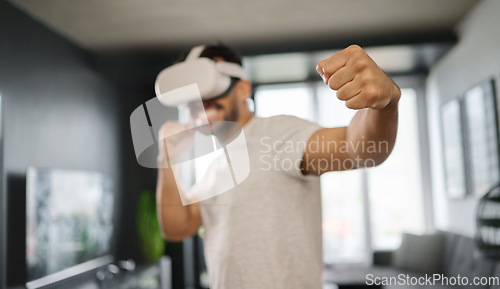 Image of VR, metaverse and man boxing on a game, training for a fight and match. Futuristic, digital sports and gamer punching while playing in an augmented reality with technology glasses in a house