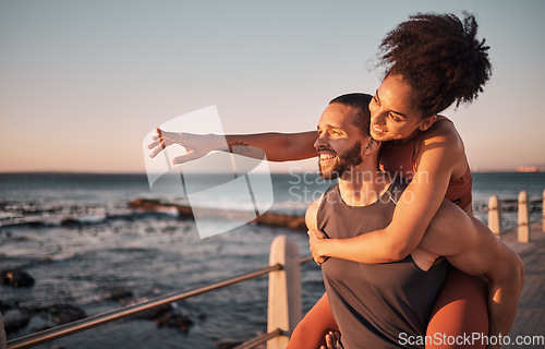 Image of Fitness, couple and piggyback for beach sunset, travel or fun holiday journey together in the outdoors. Happy man and woman enjoying back ride by the ocean coast after running exercise or workout