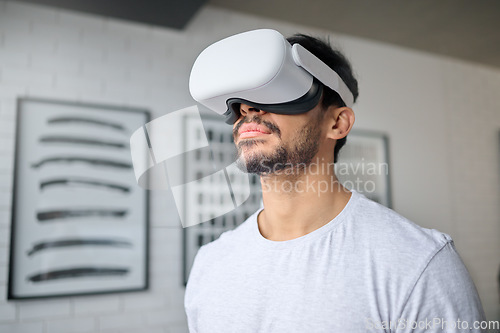 Image of Virtual reality glasses, technology and man in home with headset for streaming interactive, online and 3d games. Futuristic, digital tech and male relax with vr for metaverse, cyberspace and gaming