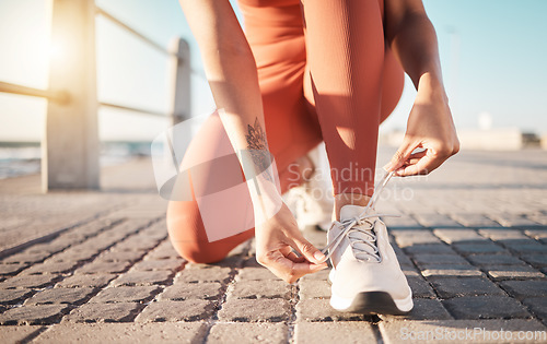 Image of Shoelace, fitness and woman ready for running, sports and training on the ground in Puerto Rico. Motivation, performance and feet of a runner tying laces to start a marathon and cardio workout