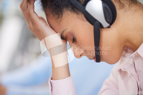 Image of Call center, headache and woman with stress from telemarketing, customer service and communication burnout. Depression, anxiety and customer support employee tired from work in technical support