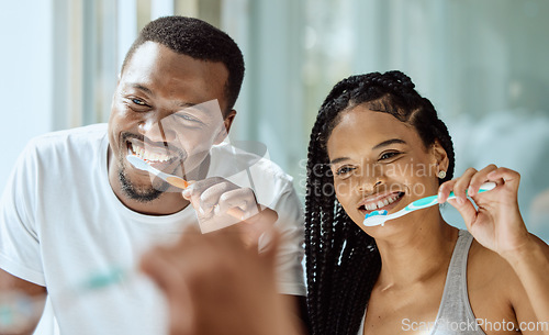 Image of Black couple, toothbrush and dental wellness in bathroom together for grooming, beauty hygiene and healthcare. African man, woman and happy oral care or brushing teeth for healthy morning routine