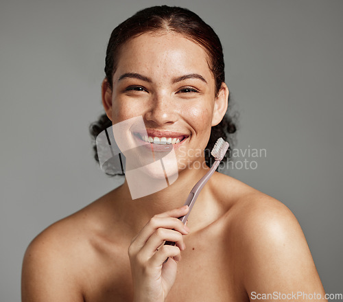 Image of Dental portrait, toothbrush and a woman brushing teeth for hygiene, cleaning and teeth whitening for wellness. Face of happy female with a smile for oral health, healthy mouth and self care in studio