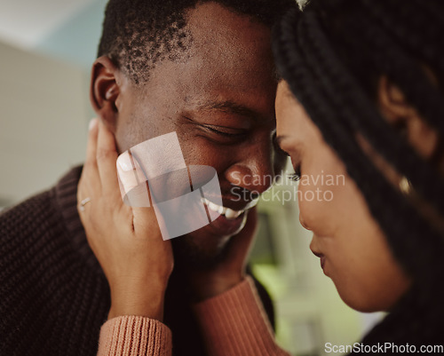 Image of Black couple, face and love while together at home with care and happiness in a healthy marriage with commitment. Young man and woman intimate while in the kitchen to bond in their house or apartment