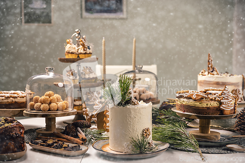 Image of Fancy sweets table with variety of Christmas desserts,