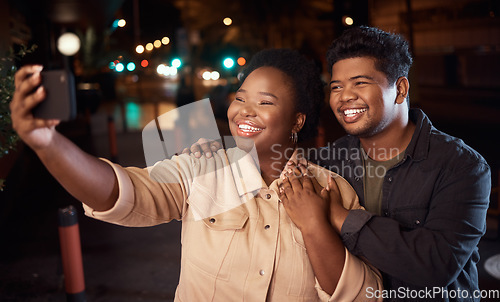 Image of Couple of friends, phone or night selfie on city street or road for social media, profile picture or birthday celebration vlog. Smile, happy or bonding people on mobile photography technology in dark
