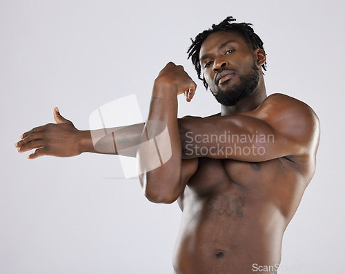 Image of Black man, fitness and stretching portrait with sports person in studio for strong body and muscle. Health and wellness of a male bodybuilder model with goals for exercise, workout and training