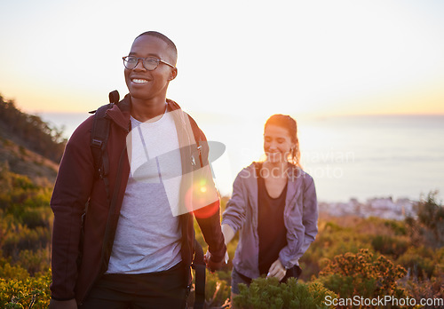Image of Interracial couple, workout and hiking exercise in sunset on a mountain as morning fitness in nature. Happy people, man and woman in a relationship training for health and wellness together