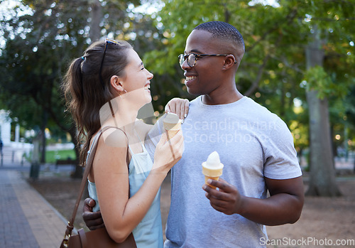 Image of Love, ice cream or couple of friends hug in a park on a romantic date in nature in an interracial relationship. Bonding, relaxed black man and happy woman enjoying a snack on a fun holiday vacation