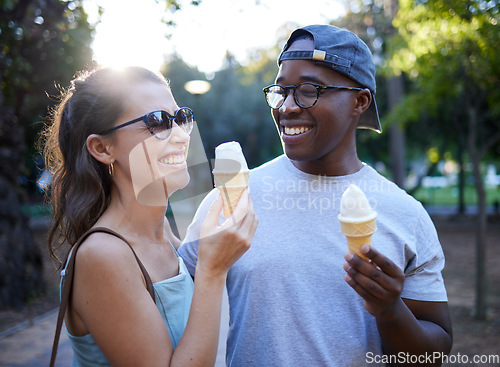 Image of Interracial couple, laughing and ice cream in a park for funny joke, conversation or bonding together. Happy man and woman sharing laugh with smile for humor, trip or holiday with desert in nature