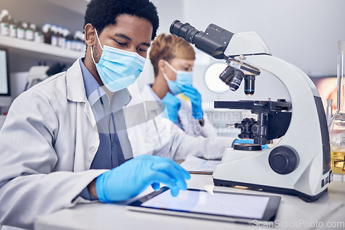 Image of Science, covid and black man in laboratory with microscope and face mask, search and motivation in vaccine development. Healthcare, scientist man or pharmacist with innovation in lab research.