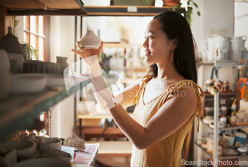 Image of Pottery, small business and display with a woman entrepreneur working in a studio, selling products for retail. Startup, manager or sale with a female owner at work in a workshop for artistic design