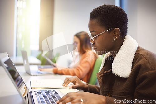 Image of Education, black woman and laptop for studying, knowledge and learning in classroom. African American female, student and academic with online research, study notes or prepare for exam, test or focus
