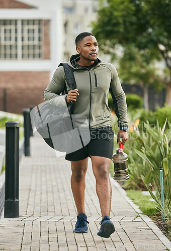 Image of Fitness, travel or black man walking to gym for body training, exercise or workout with water bottle or gym bag in Atlanta. Path, mindset or healthy sports athlete with wellness goals or motivation