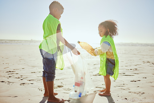 Image of Children, plastic bottles or beach clean up in climate change, environment sustainability or planet earth recycling. Boy, girl or students in cleaning sea, ocean waste management or community service